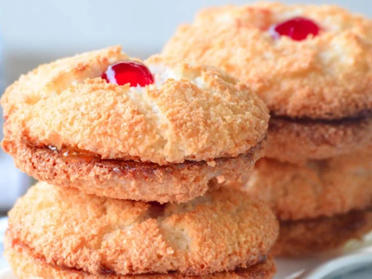 Coconut cookies topped with red cherries