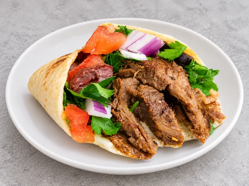 Beef shawarma sandwich with vegetables and pickles