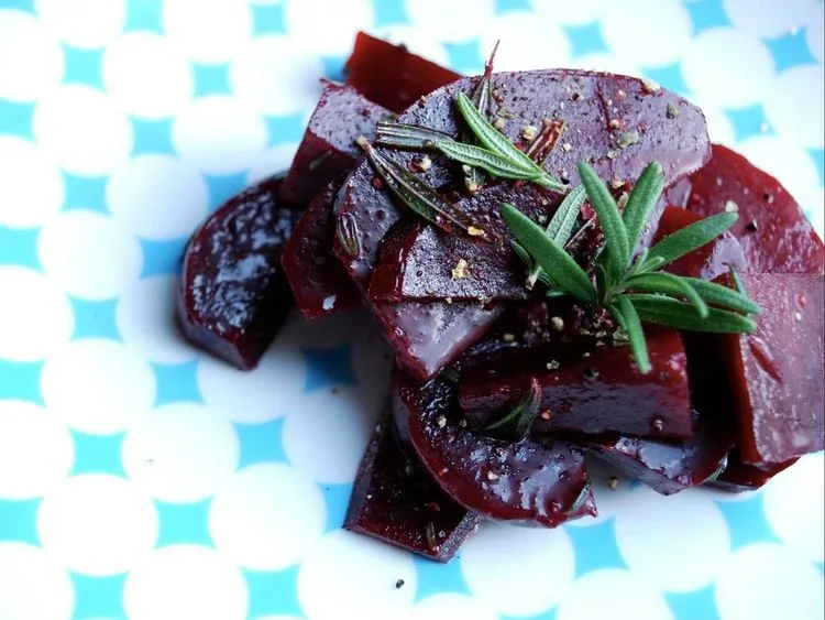 Marinated beet cubes garnished with rosemary