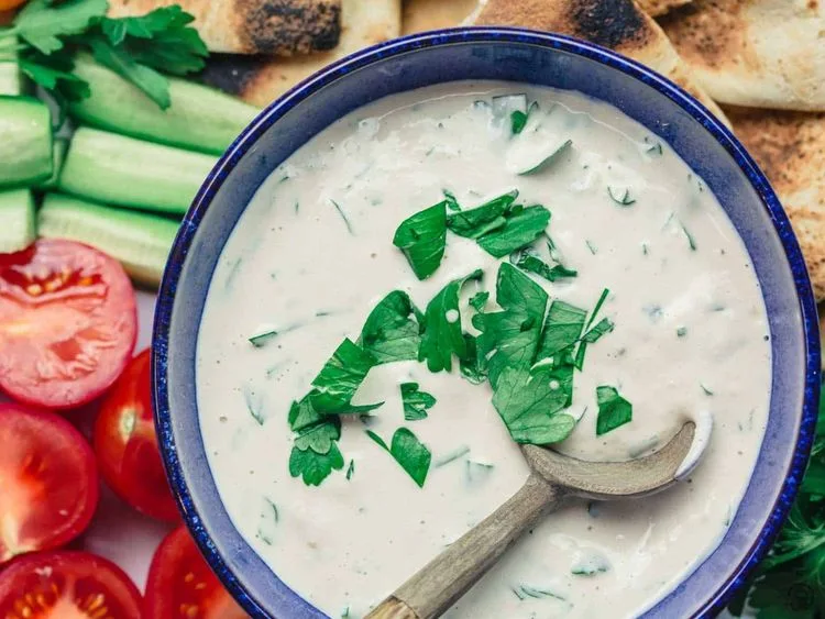 Tahini sauce topped with herbs