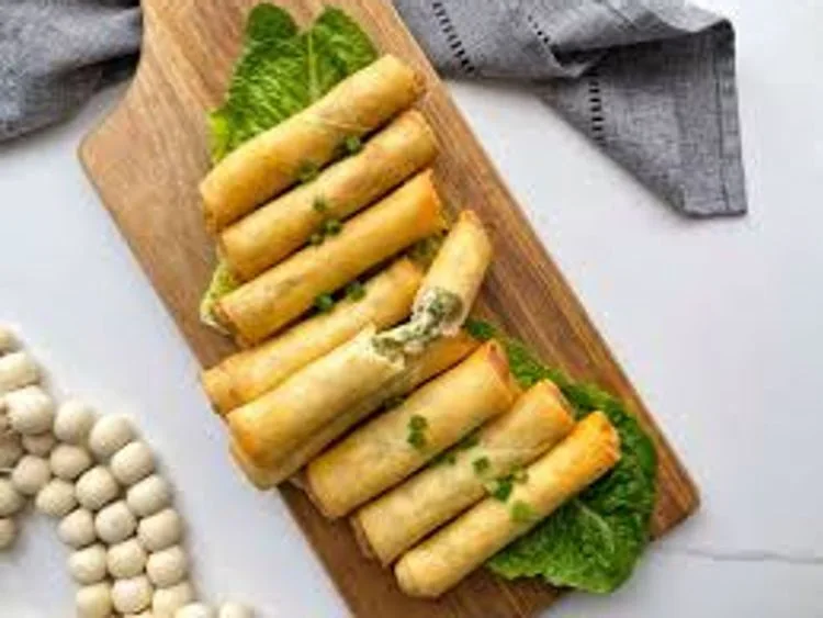 Golden cheese rolls on a wooden board