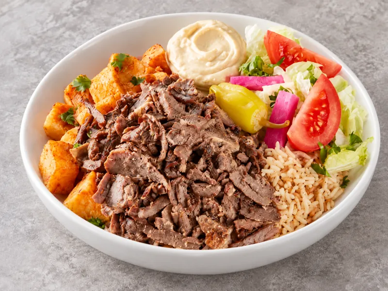 Beef shawarma bowl with rice, vegetables and dips