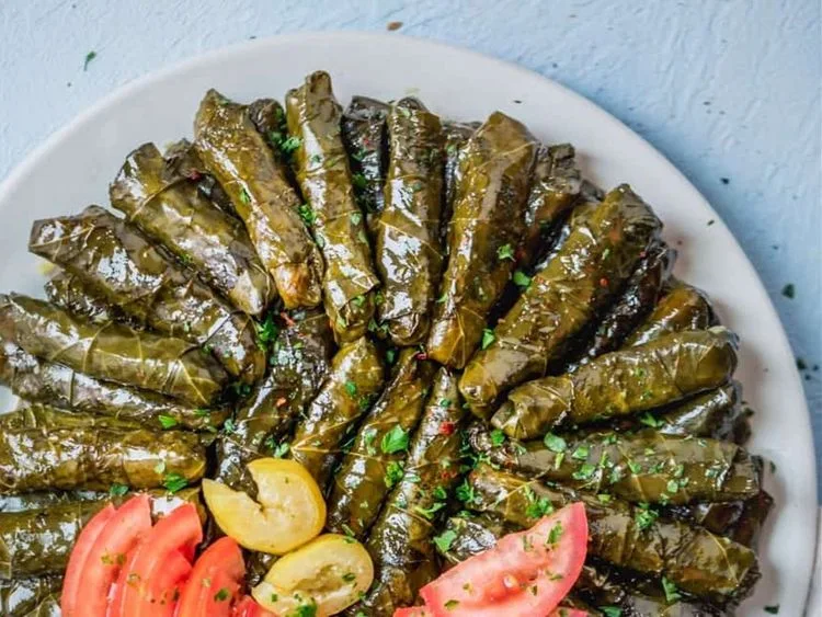 Stuffed grape leaves arranged on a plate