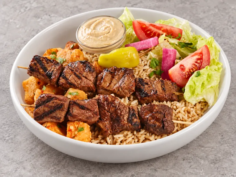 Beef kabab bowl with rice, vegetables and dips