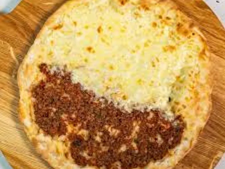 Flatbread topped with meat and cheese