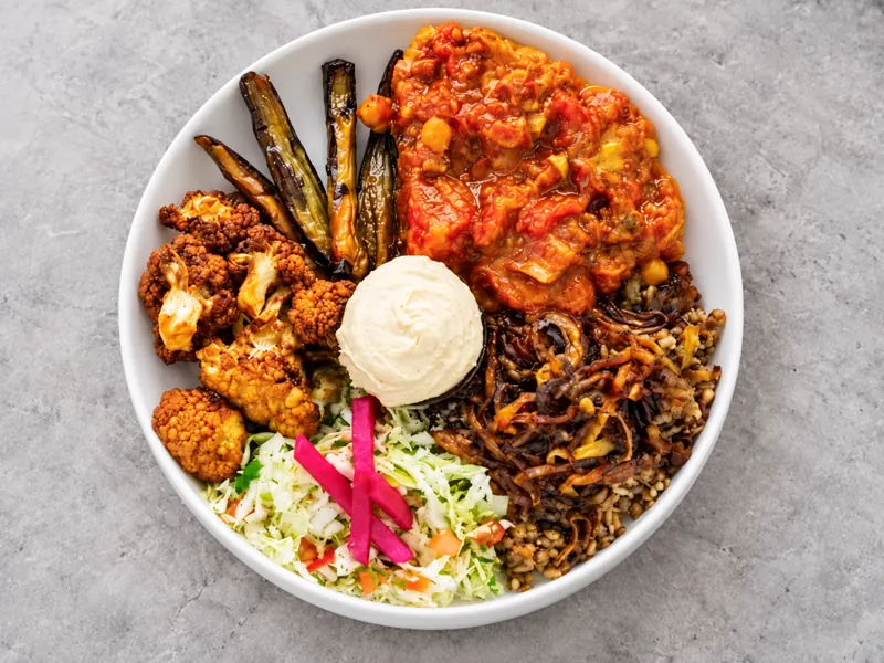 Vegetarian bowl with roasted vegetables and dips